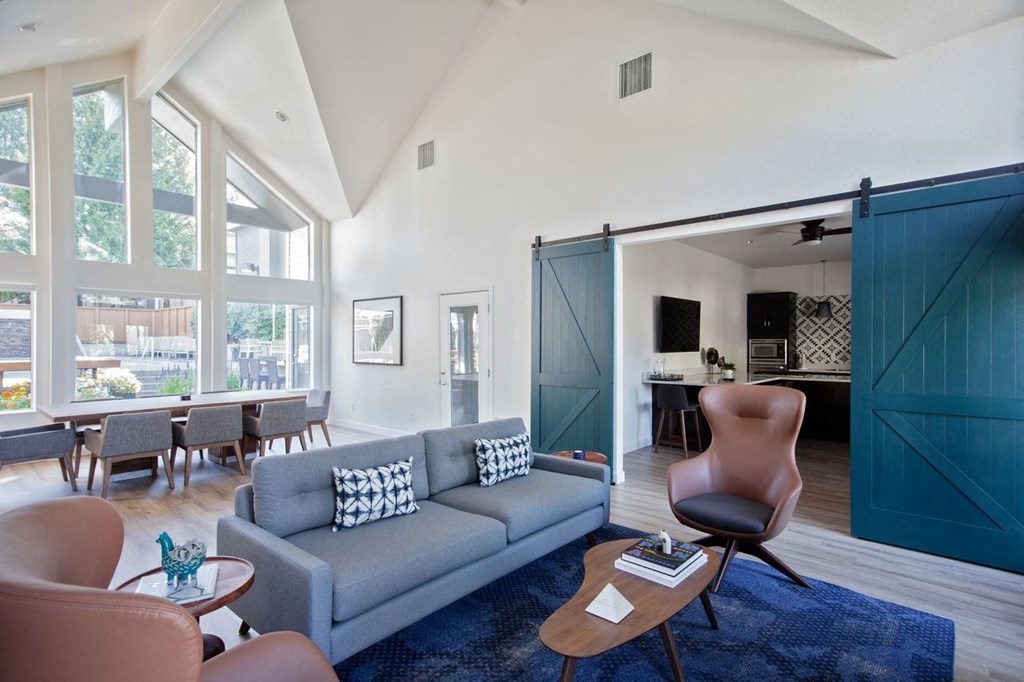 a living room with a blue couch and a sliding barn door