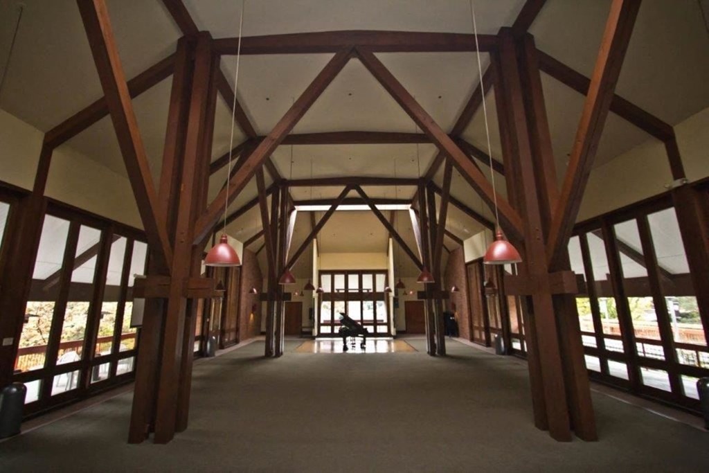 the inside of a building with wooden beams and windows