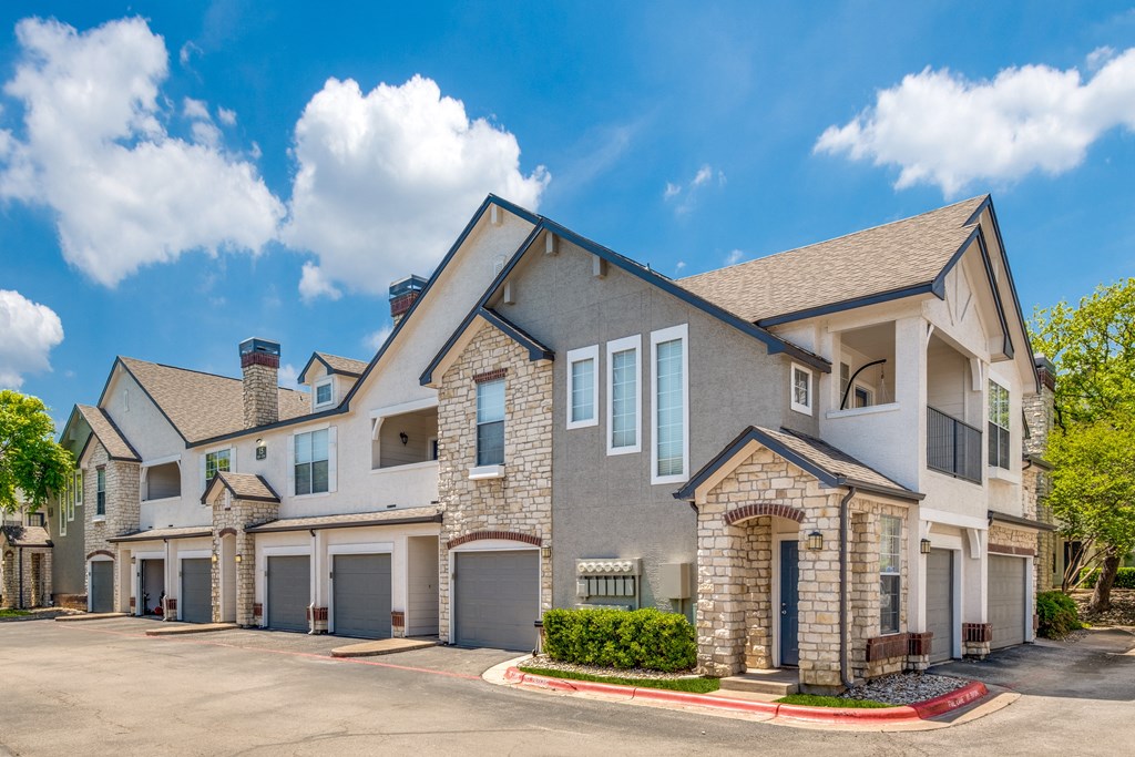 external view of a house with a driveway and garage doors