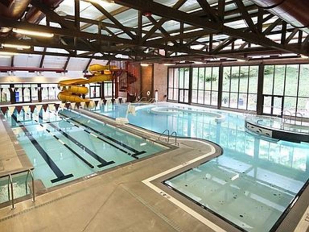 Pet-Friendly Apartments in Mountain Park, OR - MiLO at Mountain Park - Indoor Pool with Waterslide, Jacuzzi, and Floor-to-Ceiling Windows