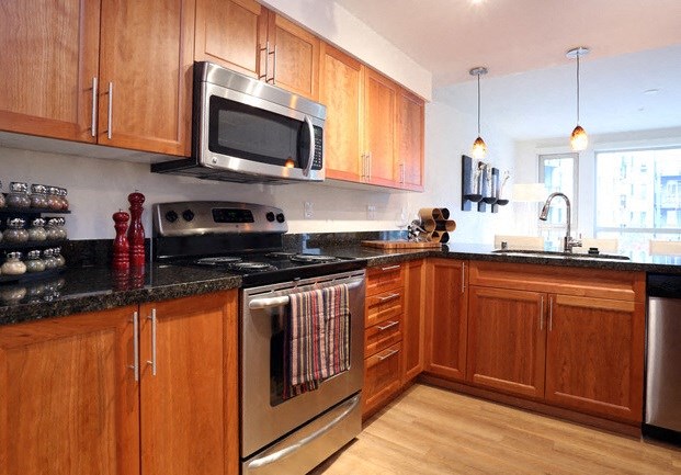 a kitchen with stainless steel appliances and wooden cabinets