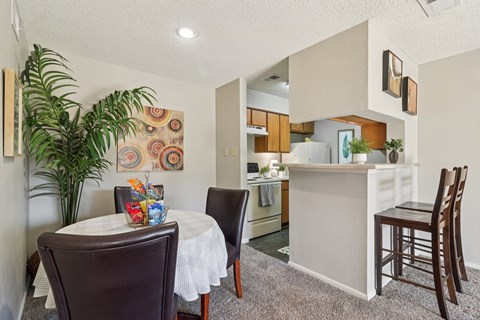 A dining room with a table and chairs.