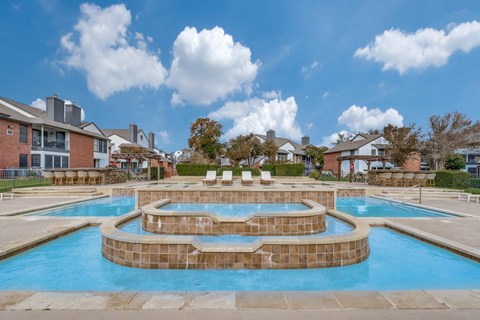 Austin, TX, Apartments Near Rattan Creek Park - The Flats on San Felipe - Swimming Pool With A Raised Spa, Lounge Chairs, Poolside Seating, and Pergolas.