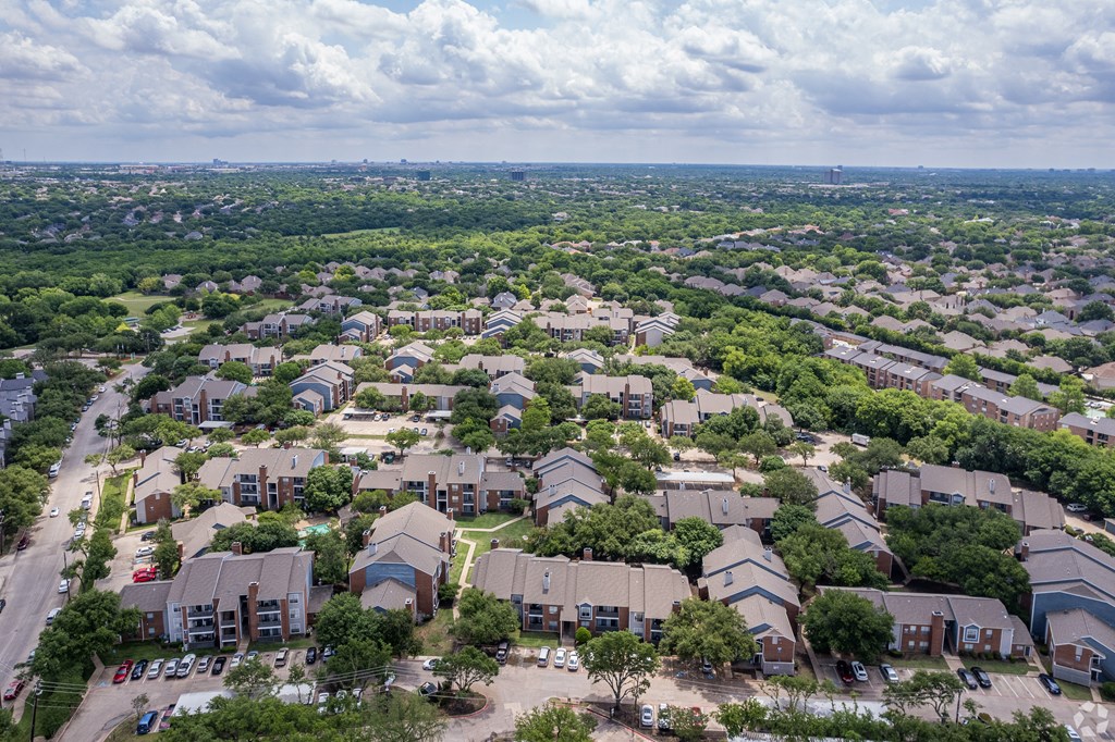 an aerial view of a neighborhood with houses and trees