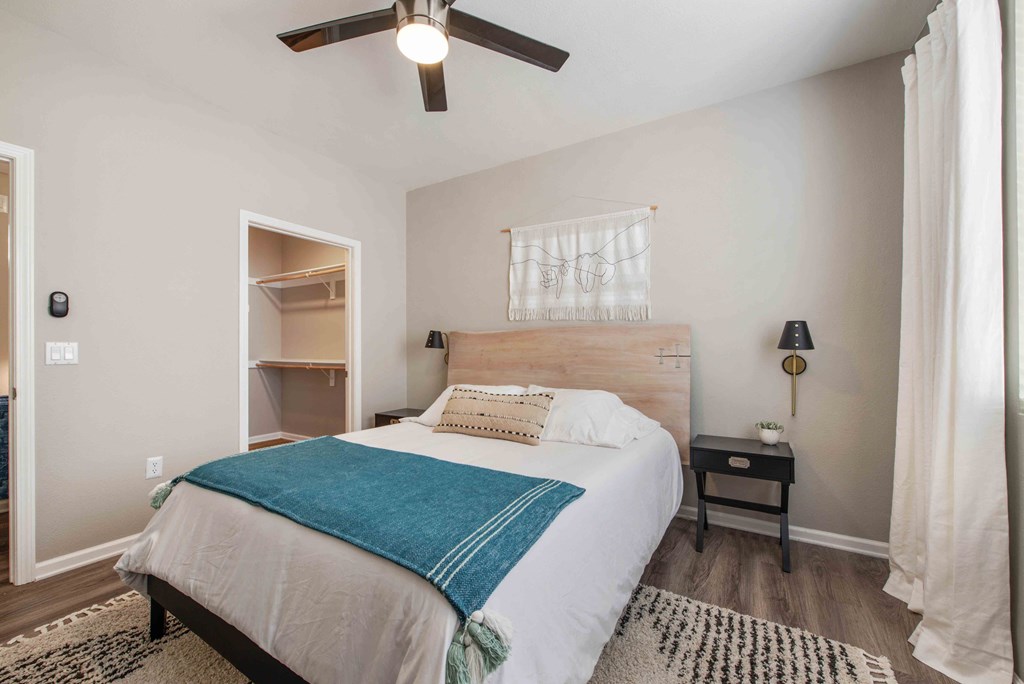 a bedroom with a bed and a ceiling fan
