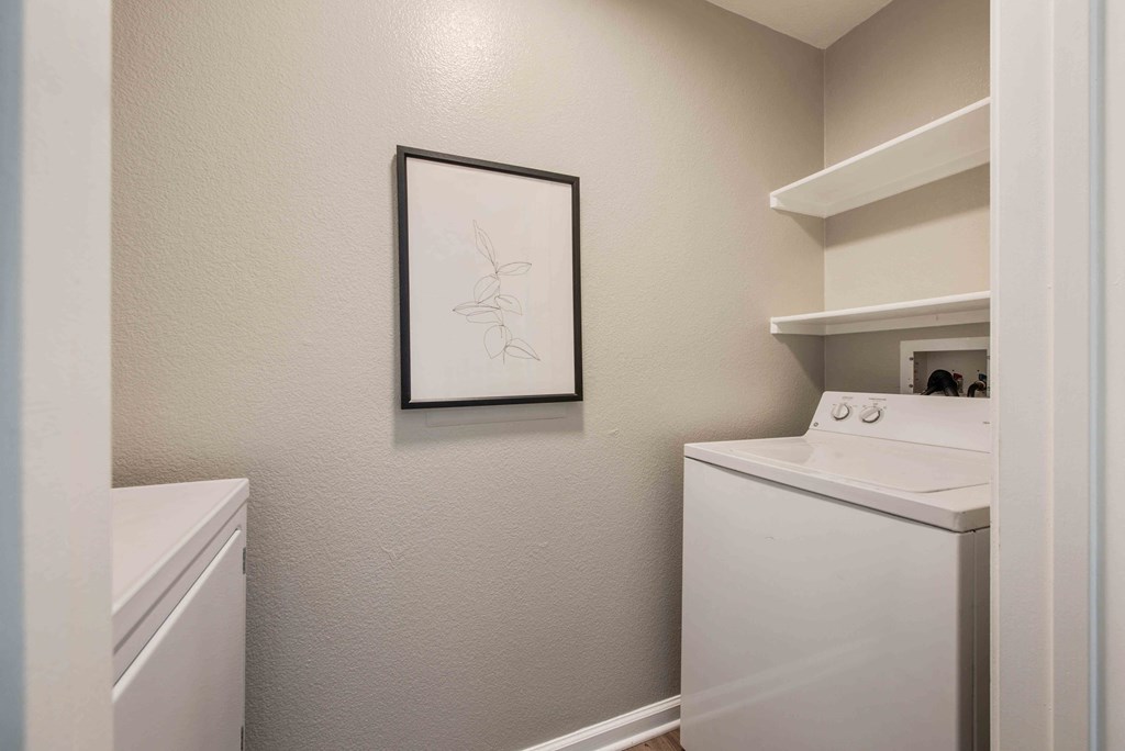 a white laundry room with a washer and dryer in it