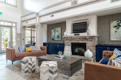 A living room with a fireplace and a television on the wall.