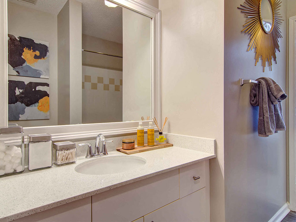 The Ascent at Windward apartments in Alpharetta Georgia photo of bedroom with adjacent bathroom