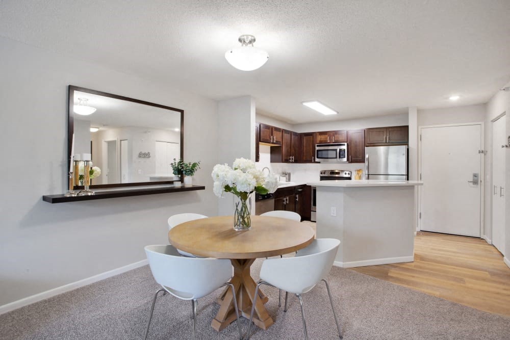 a kitchen and dining room with a table and chairs