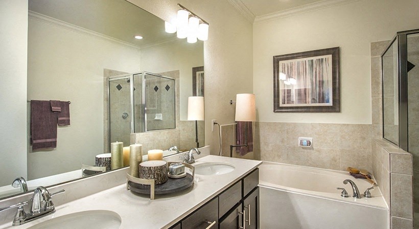 a bathroom with a sink and a tub and a mirror