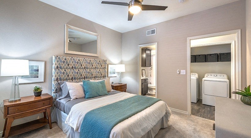 a bedroom with a bed and a ceiling fan