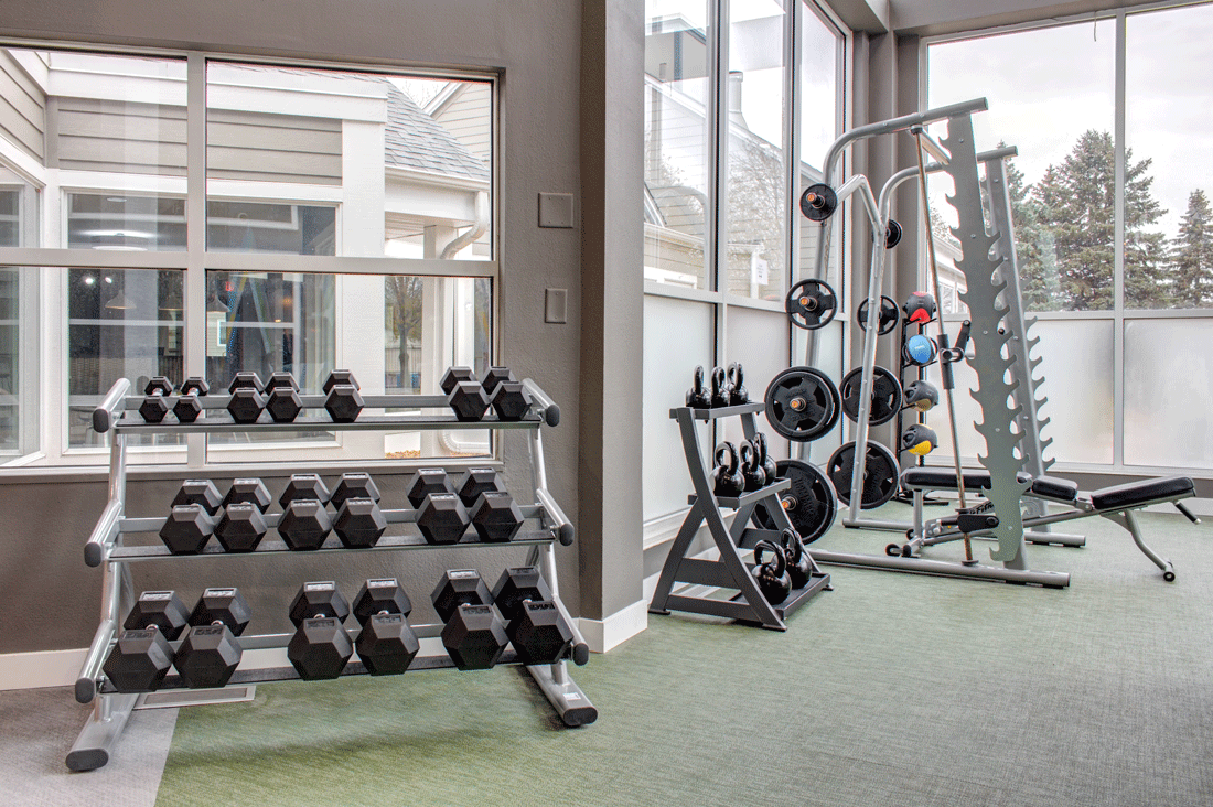 Free weights in fitness center, smith machine