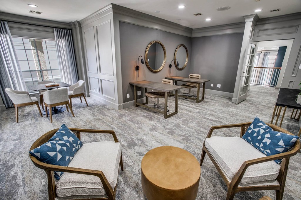 a living room with chairs and tables and a couch