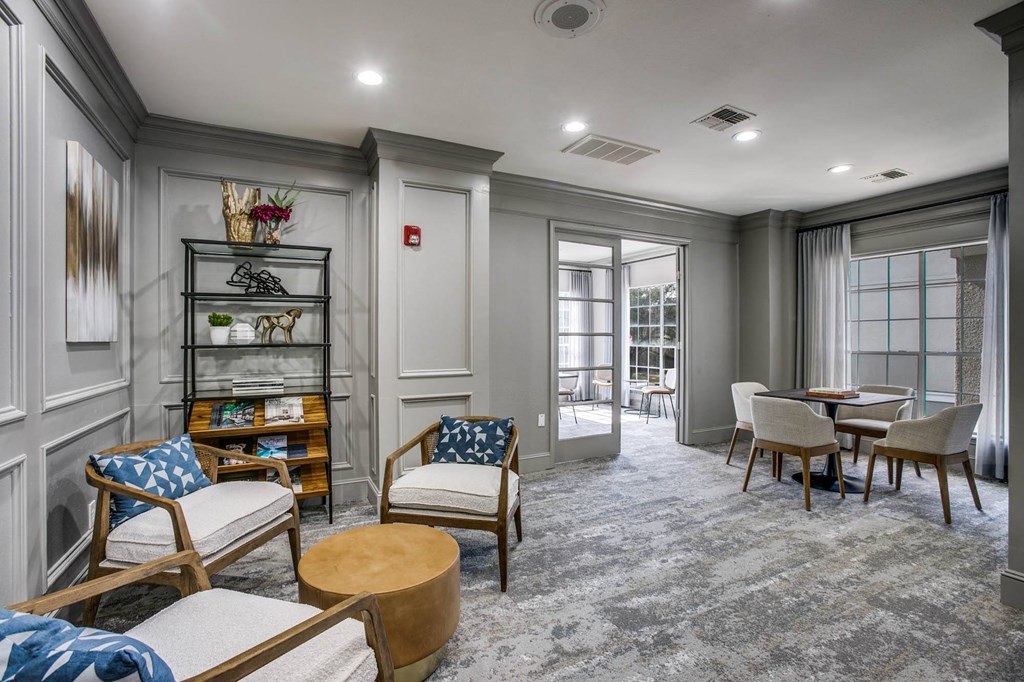 a living room with a couch and chairs and a table