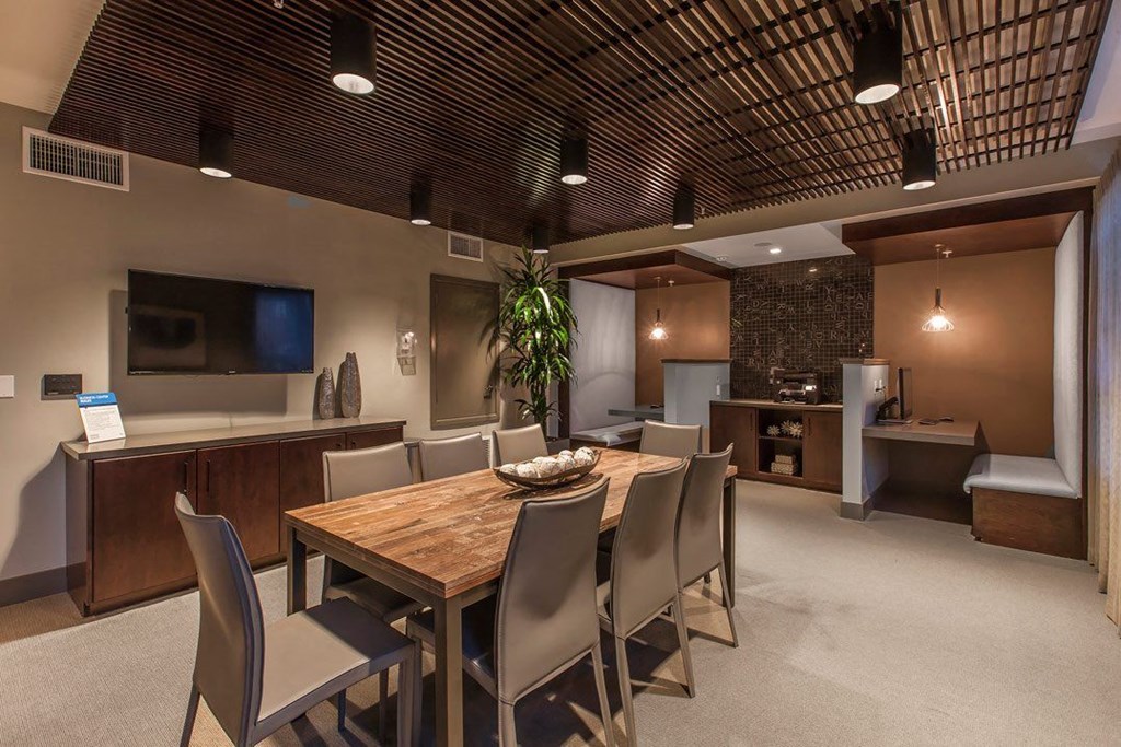 a dining room with a wooden table and chairs