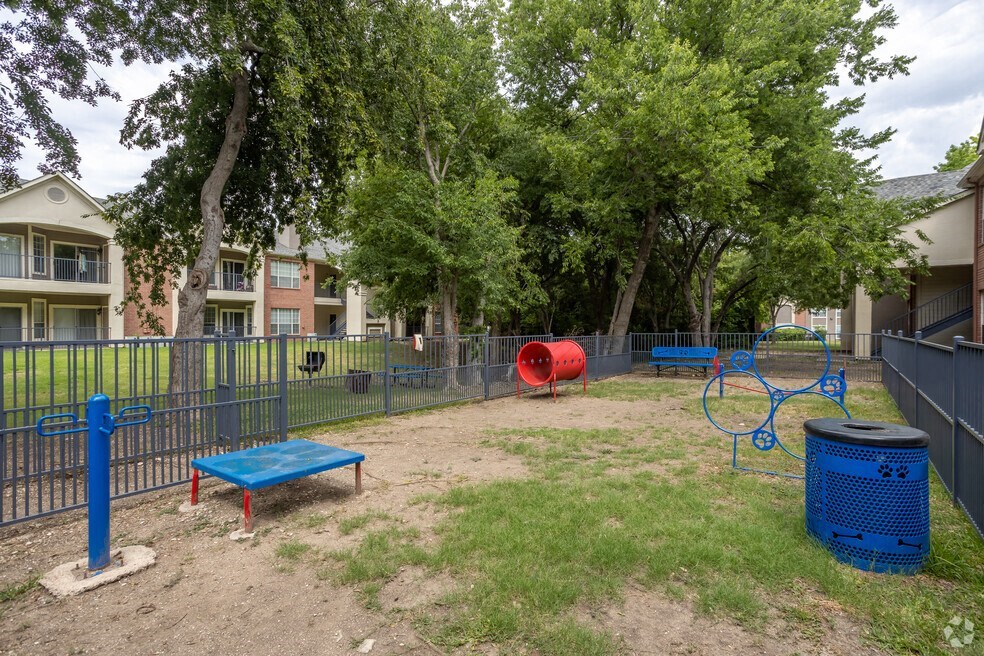 a video game of a park with a playground and trees
