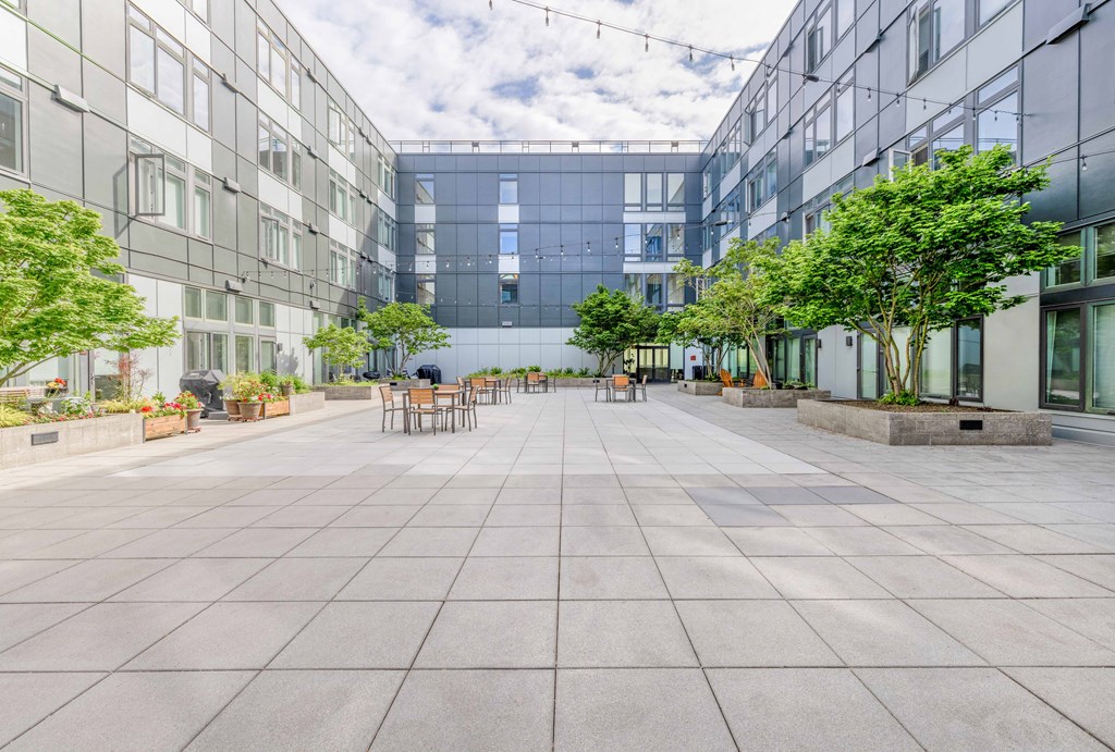 a courtyard with trees and chairs