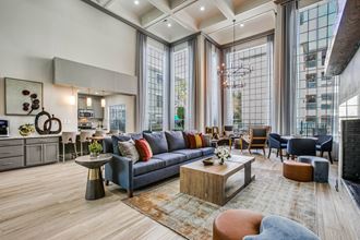 a living room with large windows and a couch