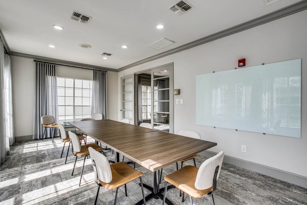 a conference room with a long wooden table and chairs