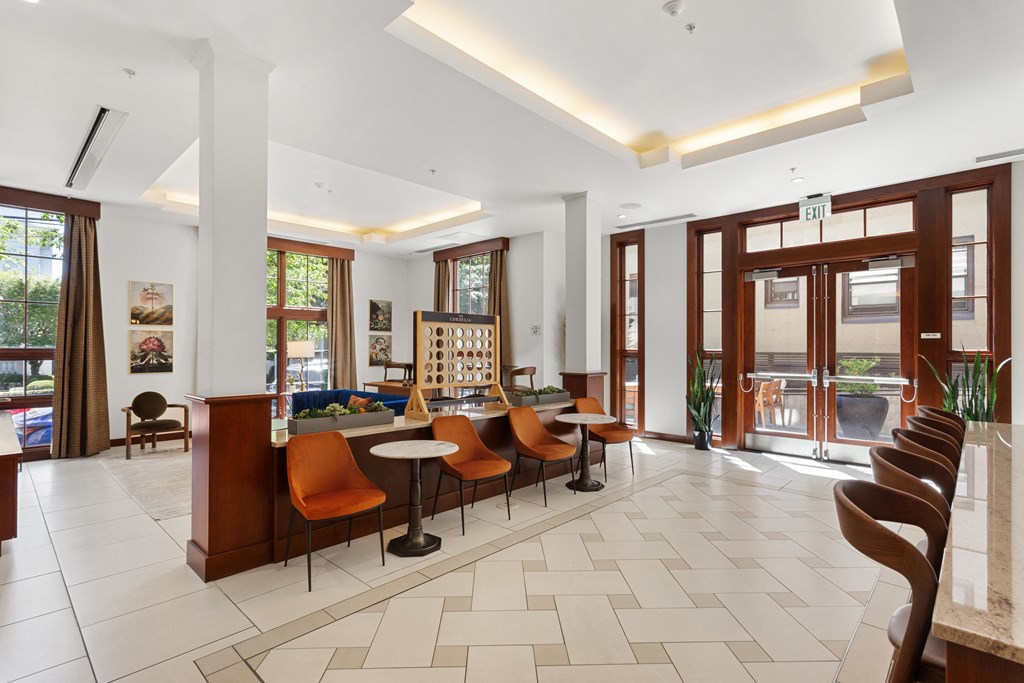 the lobby of a hotel with a reception desk and chairs