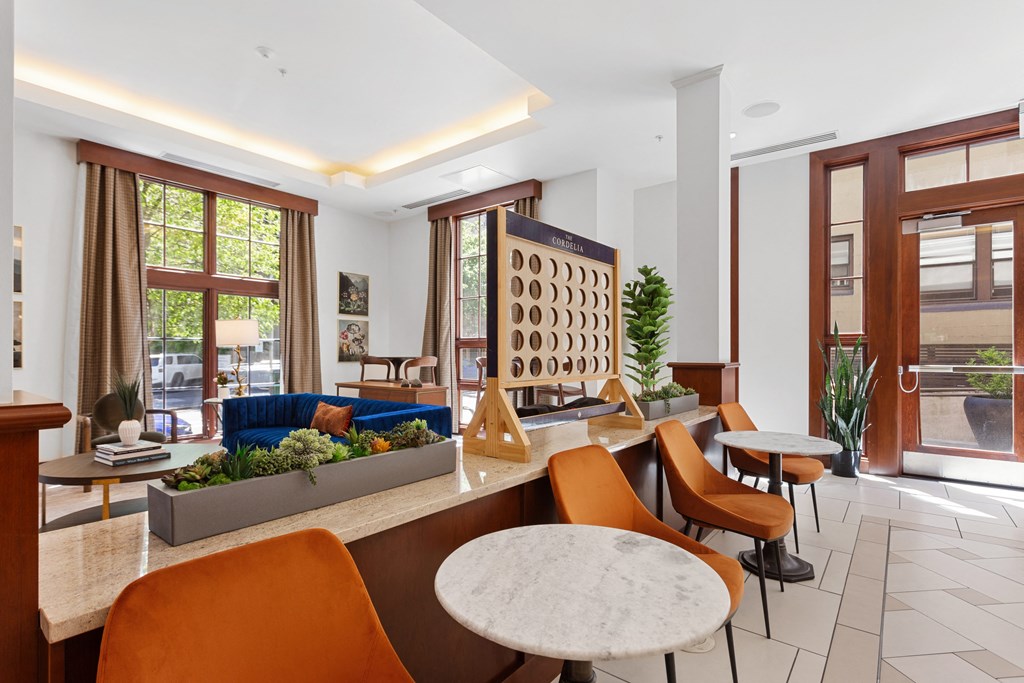 a living room with tables and chairs and a blue couch