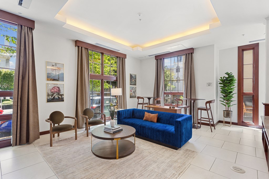 a living room with a blue couch and a table