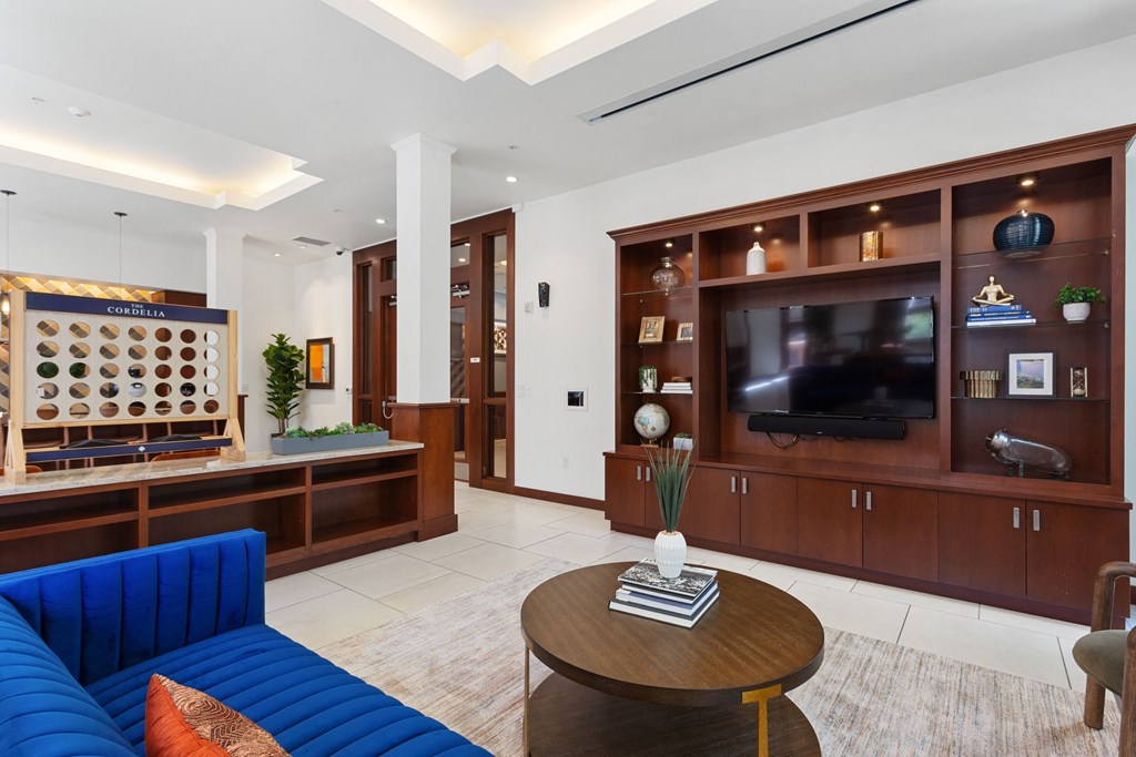 a living room with a blue couch and a television