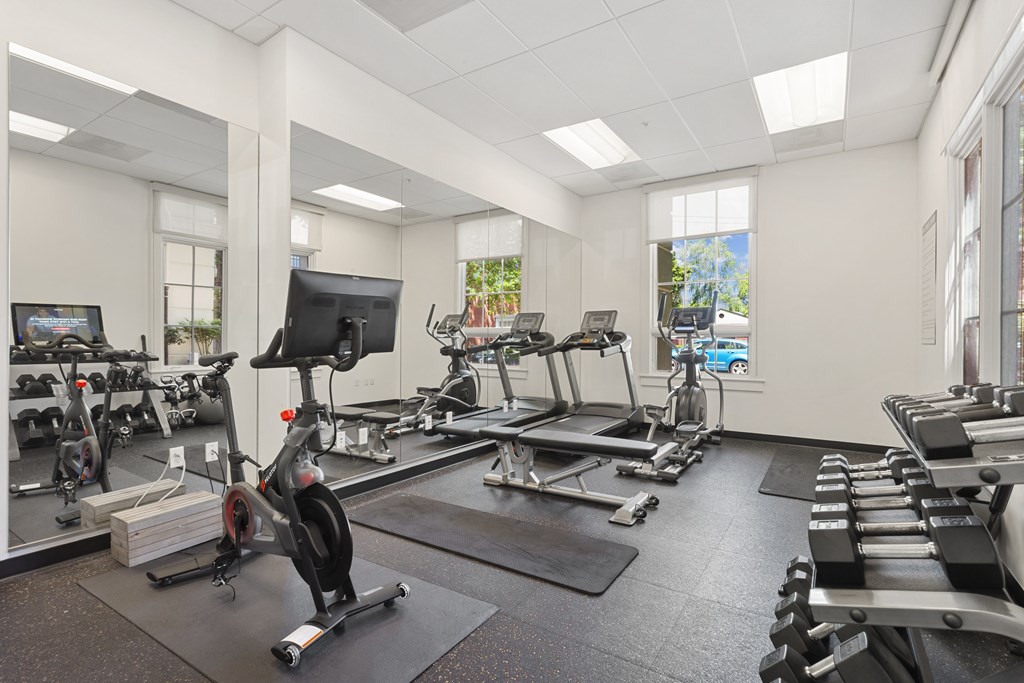 the gym with treadmills and other exercise equipment at the belgard apartments
