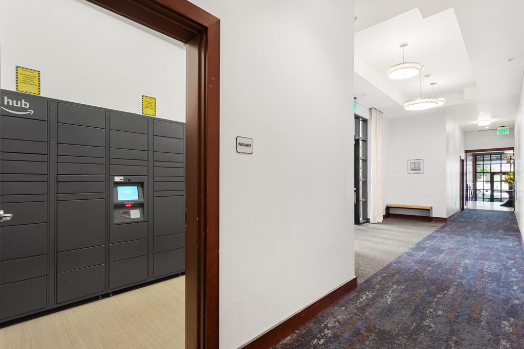 a view of a hallway with a row of lockers and a door