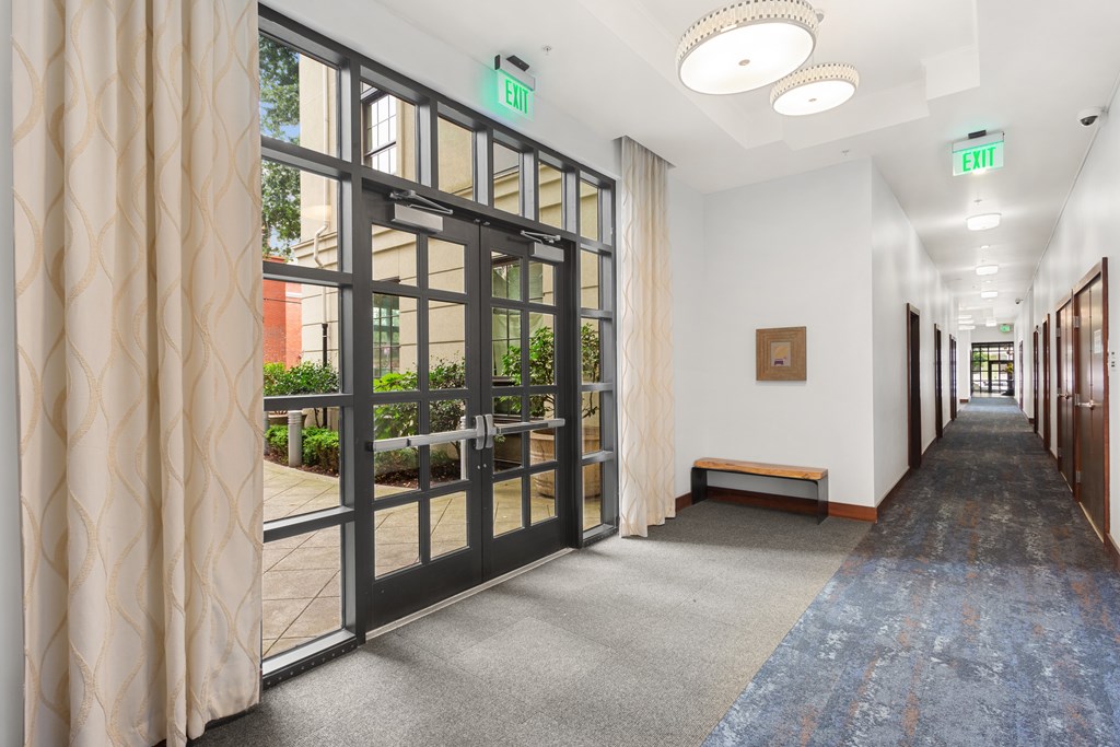 a hallway with doors and windows in a building