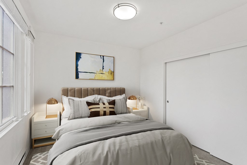 a bedroom with a bed and a large window