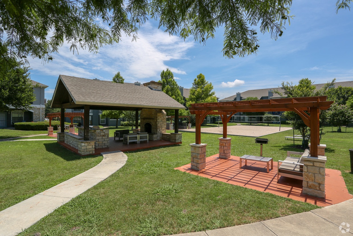 a pavilion with a picnic table in a park