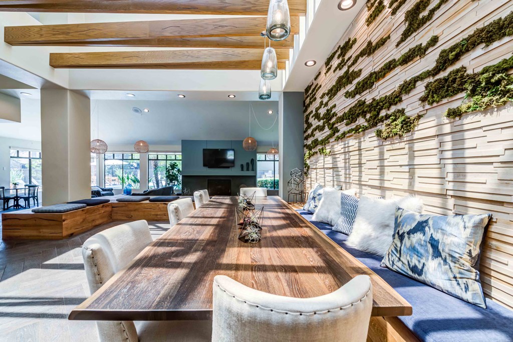 clubhouse lounge room with tables and tv's