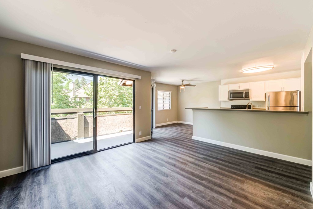3 BR Apartments in Rancho Cucamonga CA - Creekside Alta Loma - Open-Concept Living Room with Large Sliding Glass Door to Balcony/Patio Adjacent to the Dining Room and Kitchen.