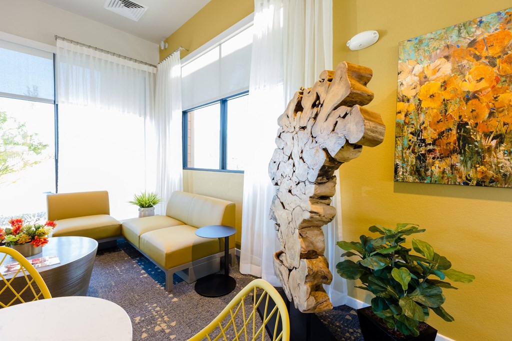 a living room with a tree sculpture in the corner