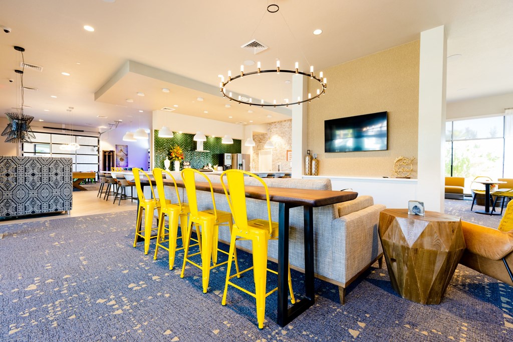 a dining room with yellow chairs and a table
