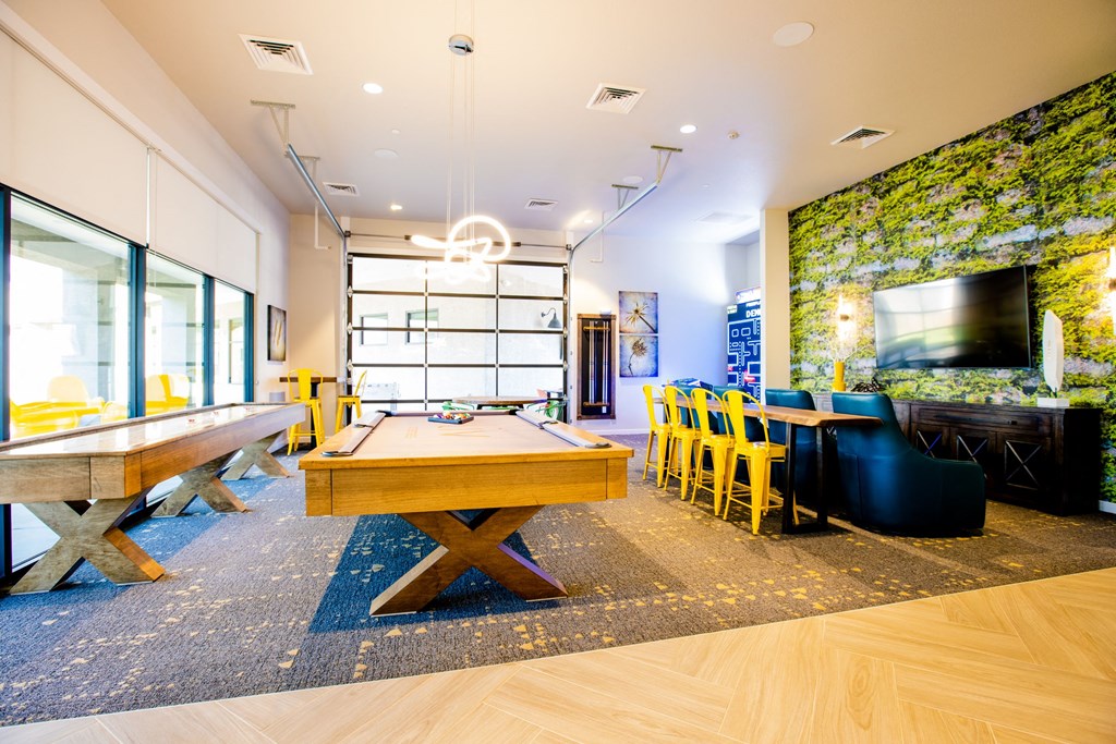 a game room with a pool table and a television