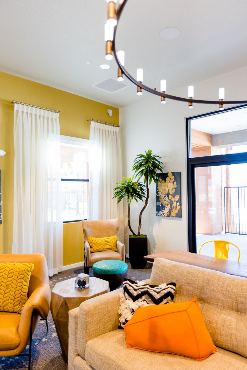 a living room with yellow walls and orange and blue furniture