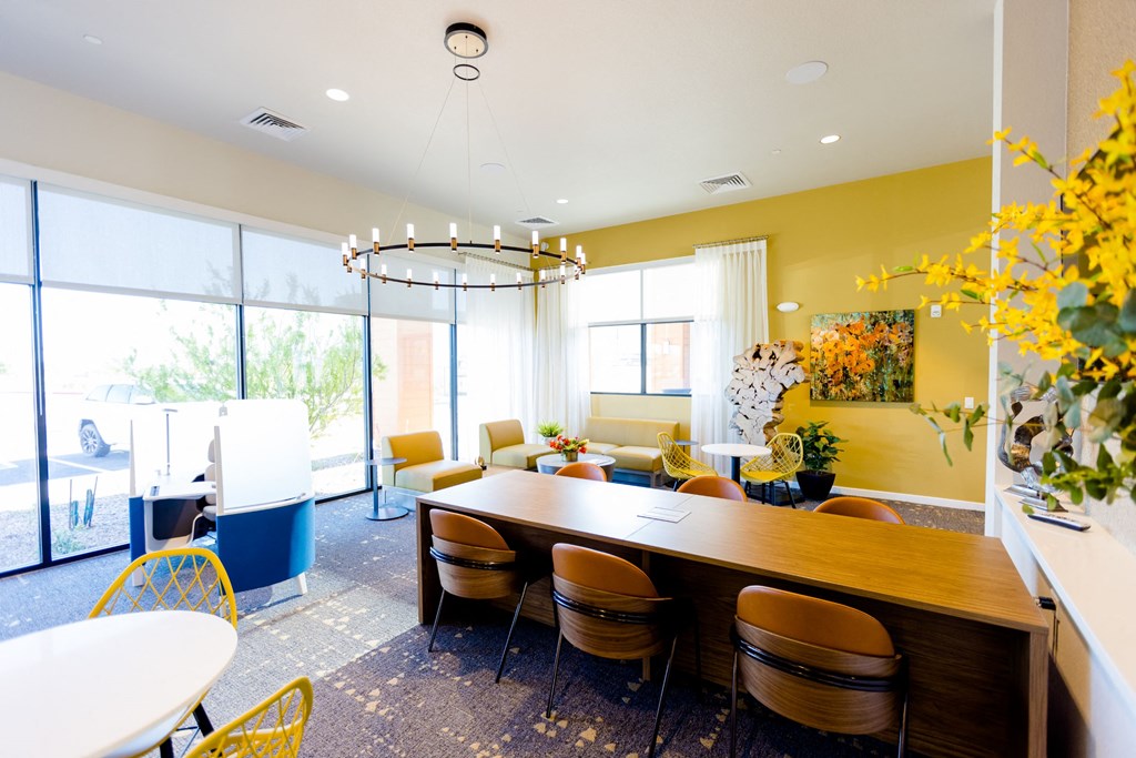 a dining room with a long wooden table and chairs