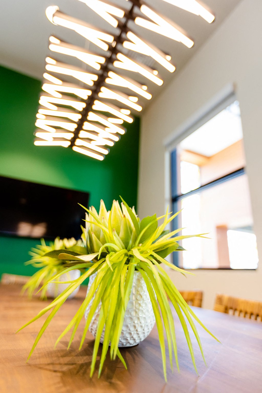 a vase with yellow flowers on a wooden table