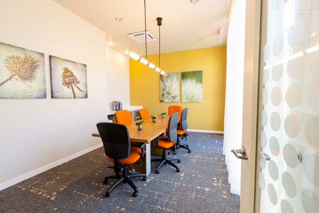 a conference room with a long table and chairs