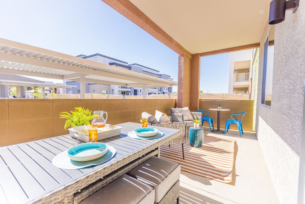 a dining area with a table and chairs on a balcony