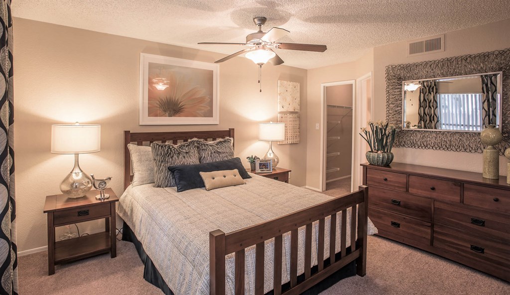 a bedroom with a bed and a ceiling fan