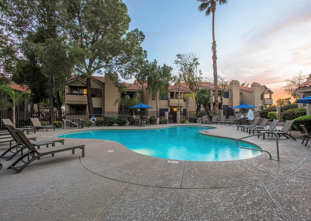 a resort style swimming pool at dusk