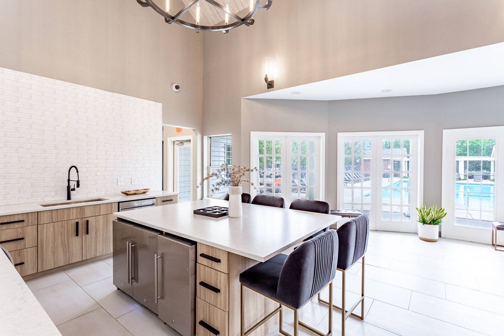 a kitchen with a large island and a chandelier