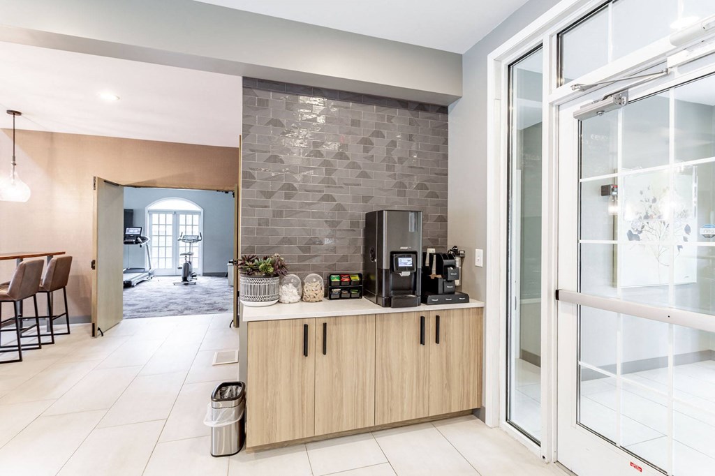 a kitchen with a coffee machine and a microwave on a counter