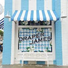 a blue and white building with a sign in the window
