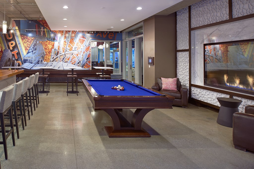 a game room with a pool table and a bar