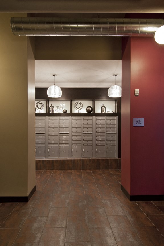 a view of the lockers in a building with a red wall