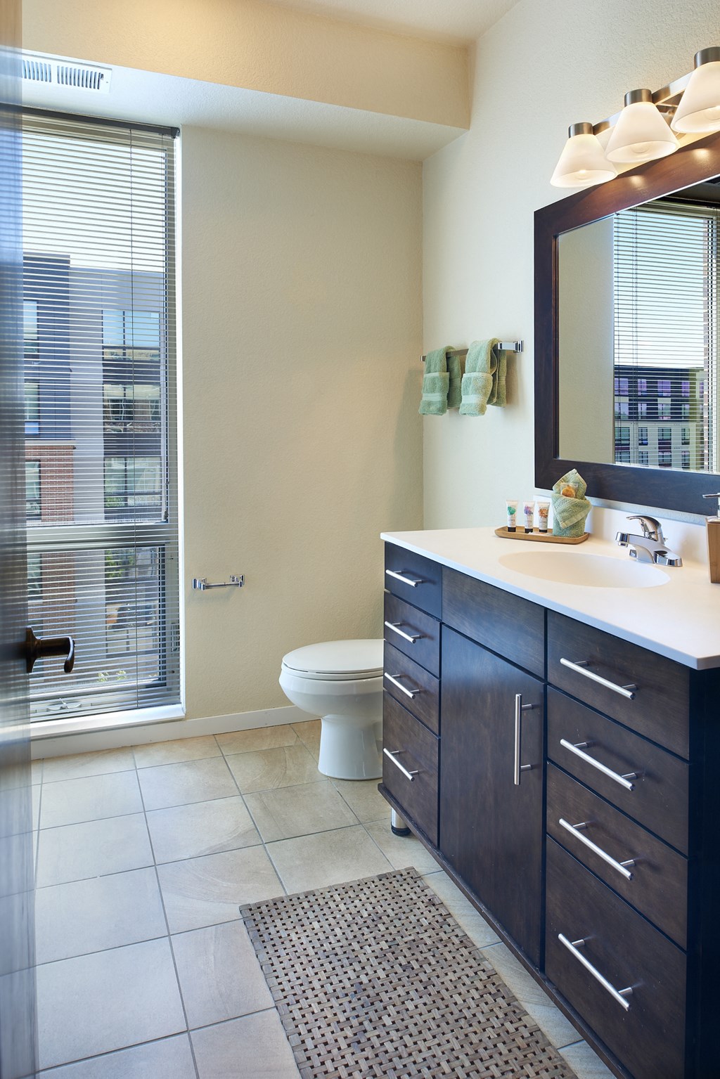 a bathroom with a toilet and a sink and a mirror